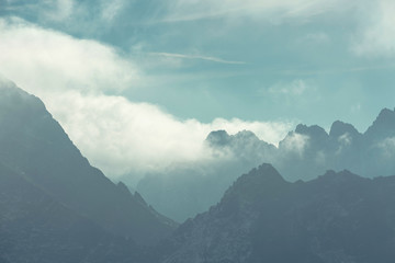 Mountain peaks in Tatra mountains and fog. Photography in pastel colors.