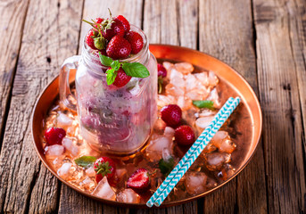 Fresh Strawberries in ain a glass Jar for Drinks on Vintage Wooden Background..Food or Healthy diet concept.Vegetarian.Copy space for Text. selective focus