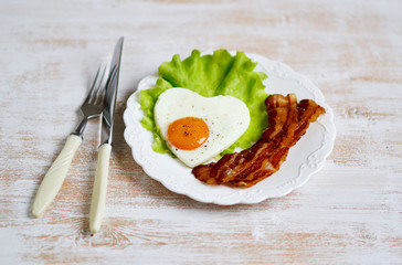 Tasty Fried Egg in the Shape of a Heart Served on a White Plate Bacon Pepper Tomato Salad Leaves Wooden Background Valentine Day Morning