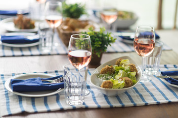 Restaurant table set with glasses, napkins and cutlery