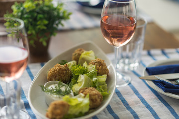 Restaurant table set with glasses, napkins and cutlery