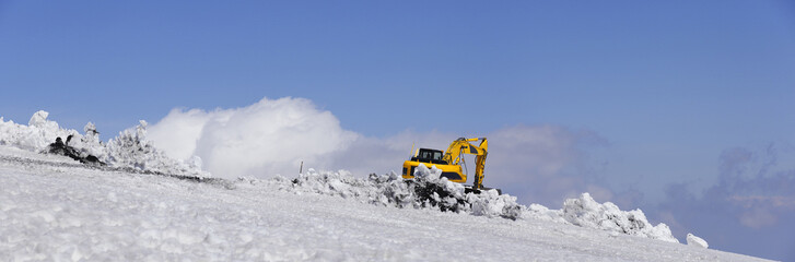 Bulldozer with shovel remove snow. Mount Etna, Sicily.