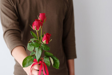 Valentine concept, Man holding red roses on white background