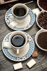 Drinks, drinking, energy and caffeine concept-coffee cups, coffee beans, ground coffee and instant on a wooden background.