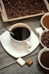 Drinks, drinking, energy and caffeine concept-coffee cups, coffee beans, ground coffee and instant on a wooden background.