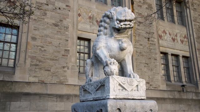 Smooth tracking shot around the Guardian Lion outside of the Royal Ontario Museum