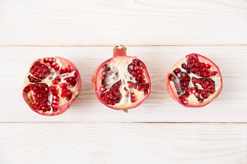 halves of pomegranate.wooden background.minimal style.top view