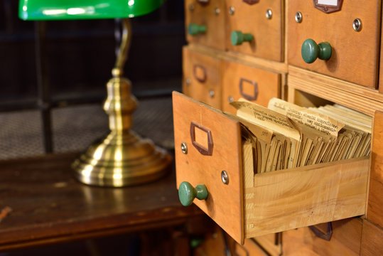 A library file with a desk and a lamp in the background.