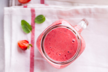 Strawberry smoothie or milkshake in jar with fresh mint.Healthy food for breakfast and snack.Super Food.Copy space for Text. selective focus.