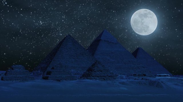 Night timelapse of the great pyramids in Giza valley during super moon, Cairo, Egypt