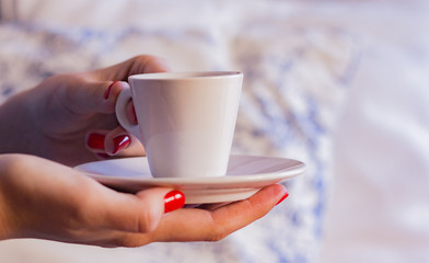 Cup of coffee and women hand
