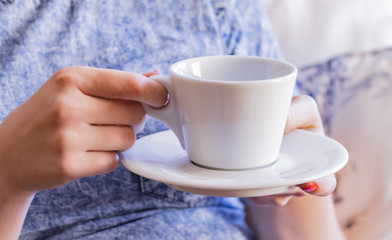 Cup of coffee and women hand