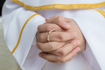 The First Holy Communion - Rosary on male finger