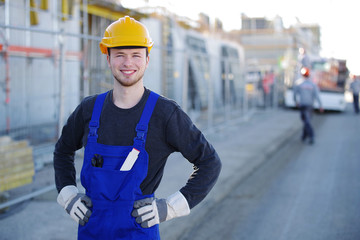 Handwerker mit nettem Lachen auf einer Baustelle 