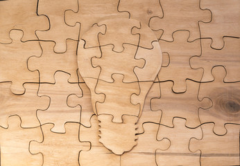a figure made of wooden puzzles lamp. ideas. logics. creation.
