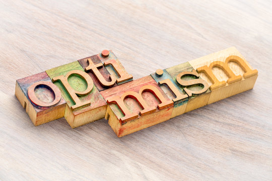 optimism word abstract in wood type