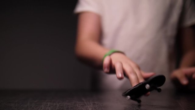 KID STICKS HIS LANDING ON A FINGER SKATEBOARD, SLOW MOTION