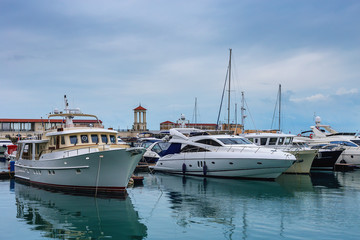 Fototapeta premium sailing boats in Havana Sochi sea port on a background marine station