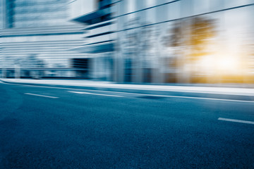 Fototapeta premium Empty urban road and modern glass building