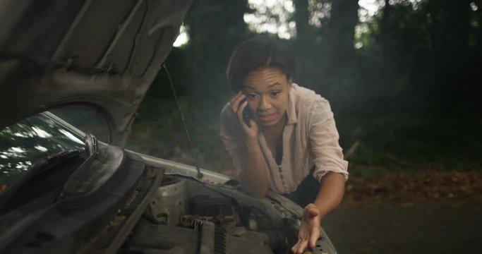 4k, A woman phoning roadside assistance because her car has broken down. Slow motion.