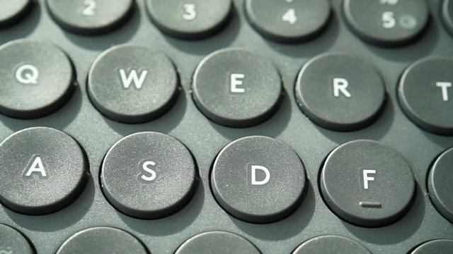 Black computer keyboard detail qwerty view closeup. Full HD with motorized slider."