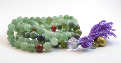 beautiful isolated jade mala with a purple tassel, praying beads