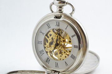 isolated vintage pocket watch with exposed gears 