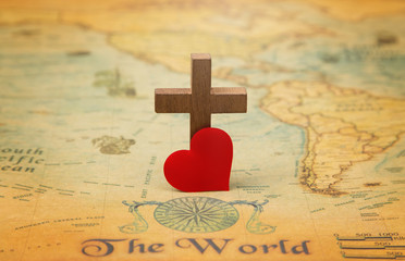 Obraz premium For God so loved the world - A Cross on a rustic world map