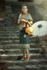 Beautiful Lao girl in traditional Laosi costume at Wat Vientiane, Laos