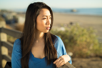 Young Asian woman looking far away