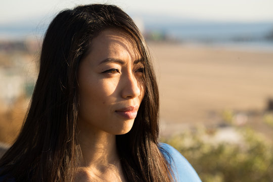 Young Asian woman looking far away
