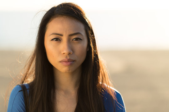Young Asian woman serious face 