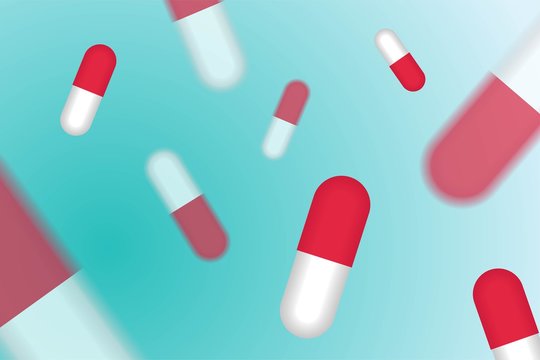 Red pills medication concept isolated in soft blue color background