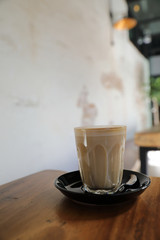cappuccino or Latte art coffee made from milk on the wood table in coffee shop