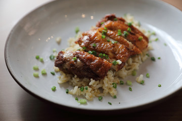 Nasi goreng fried rice with chicken on wood background