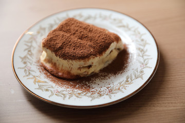 Tiramisu cake on wood background