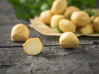 Herbs with balls of freshly made mozzarella cheese and dill and parsley on a wooden table. Selective focus.
