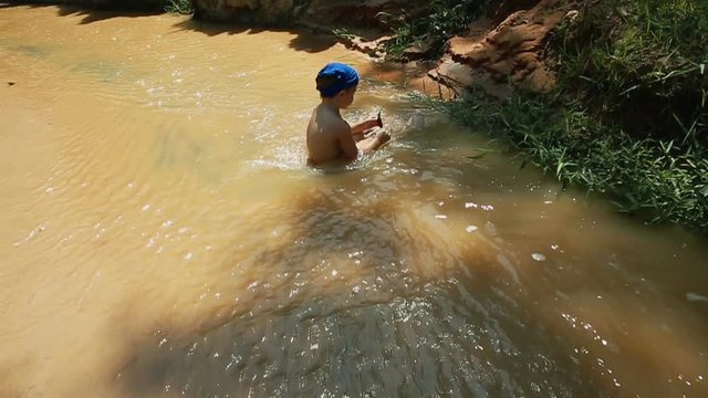 Kid traveler walking at Fairy Stream (Suoi Tien), the travel place in Muine, Vietnam
