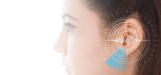 Hearing test showing ear of young woman with sound waves simulation technology
