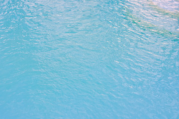 Fototapeta na wymiar The image of the water in the blue swimming pool is suitable for use as a background and a background.
