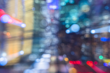 Blurred skyscrapers by night with lights trail