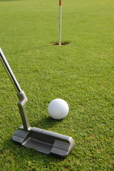 A short put in the game of golf with a ball and a putter