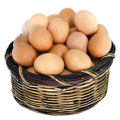 Isolated fresh eggs in wooden basket.