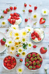 Top view of white flower bouquet with fresh strawberry on the background. Soft focus. 