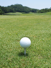 Golf balll on white tee 