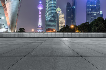 night view of empty brick floor front of shanghai skyline