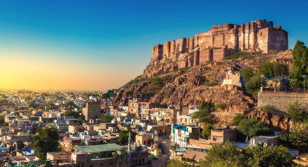Naklejka premium Historic Mehrangarh Fort with Jodhpur city scape at sunset