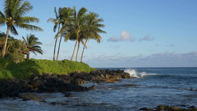 Slow motion, locked down view of Keiki Cove around sunset, in Koloa, Kauai, Hawaii.