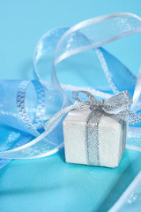 Gift box with ribbon on a blue background
