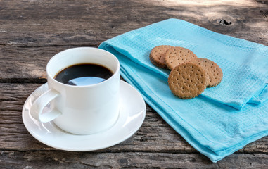 black coffee in the morning with biscuit on old wooden board 